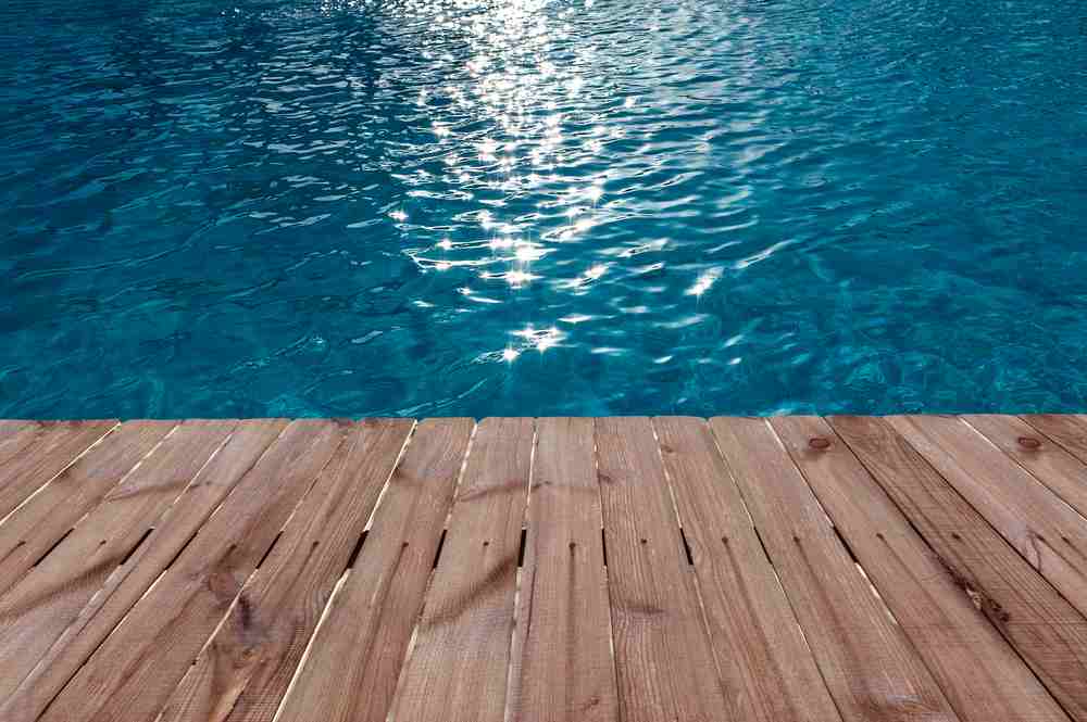 Image of a swimming pool deck by Clear Choice Pool Care, highlighting various common materials used in pool decking.