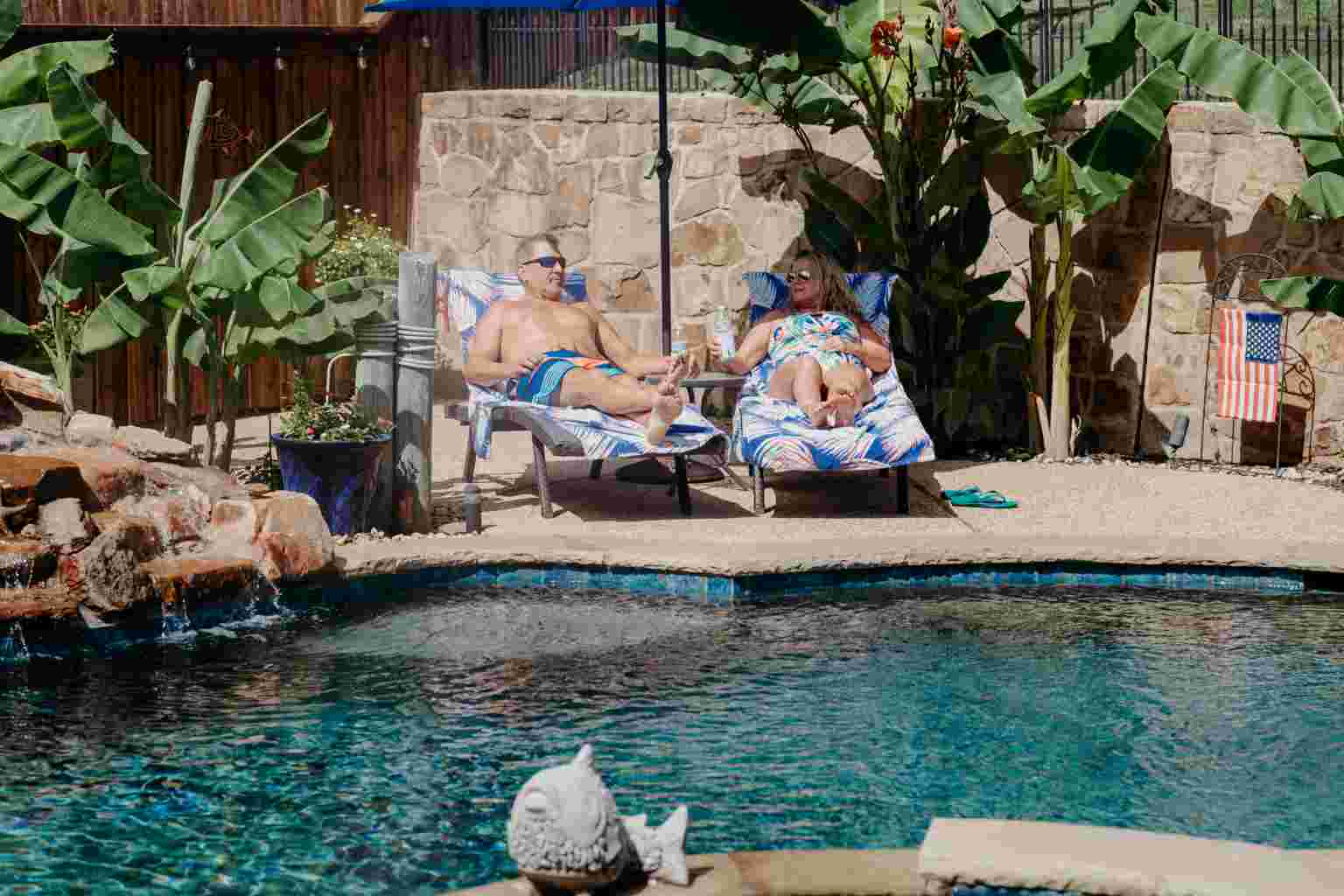 Couple relaxing by a swimming pool, featuring Clear Choice Pool Care, highlighting Pool-Coping, and aligning with the page's context.