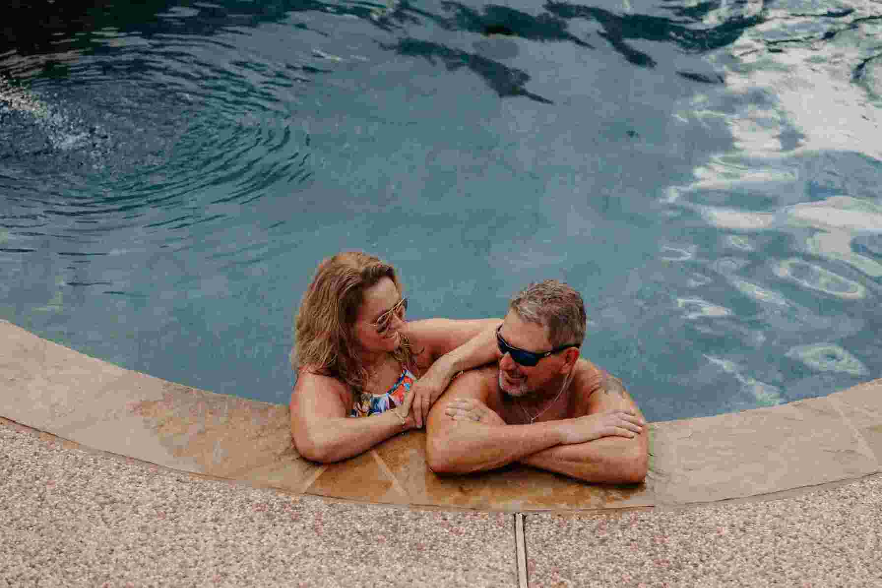 Image of a couple in a swimming pool, featuring Clear Choice Pool Care and highlighting 'Pool Water Levels Are Important to Improve the Longevity of Your Pool,' ensuring it aligns with the page's context.